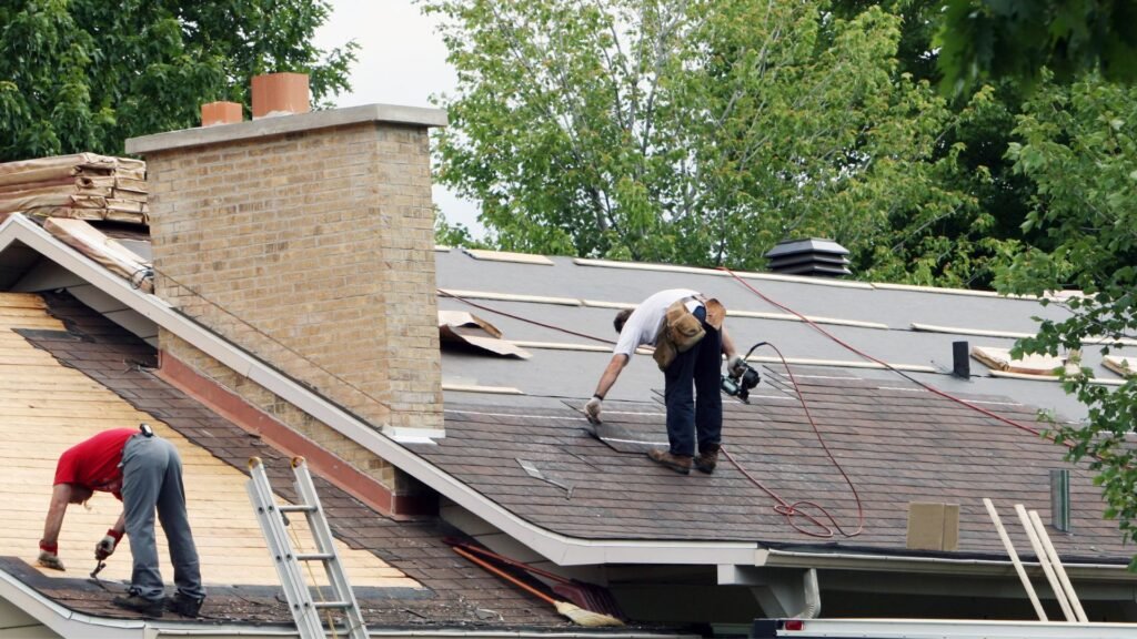 Worker installing roof membrane, roofing installation by Legends Restoration and Group