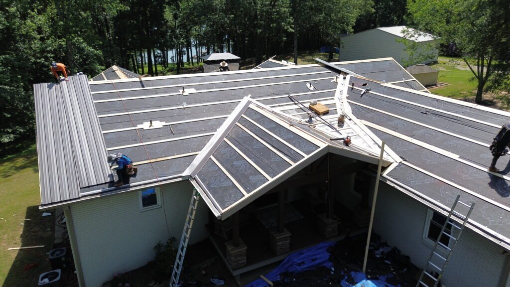 Roofing Contractor in Smyrna, GA replacing worn shingles around roof vents on a residential property