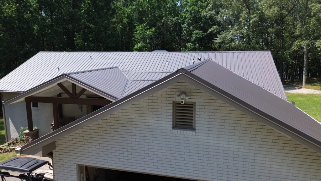 Roof Installation services in Braselton, GA completing ridge caps and ventilation on a newly installed shingle roof
