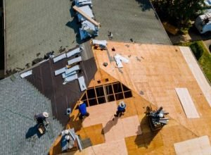 Workers constructing roof, professional roof replacement by Legends Restoration and Group