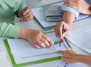 Property owner signing roof repair insurance claim – LRG